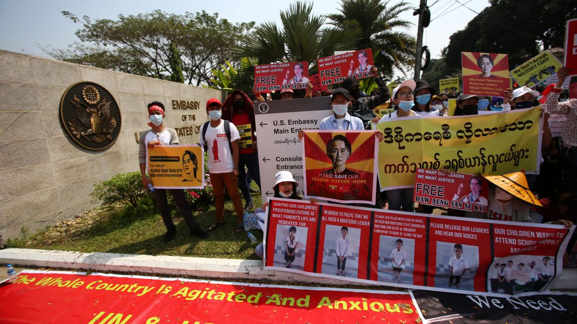 Anti-coup protesters gather outside the U.S. embassy in Yangon, Myanmar Friday, Feb. 19, 2021. A young woman who was shot in the head by police during a protest last week against the military's takeover of power in Myanmar died Friday morning, her brother said. (AP Photo)