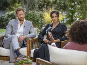 FILE - This image provided by Harpo Productions shows Prince Harry, from left, and Meghan, Duchess of Sussex, in conversation with Oprah Winfrey. Almost as soon as the interview aired, many were quick to deny Meghans allegations of racism on social media. Many say it was painful to watch Meghan's experiences with racism invalidated by the royal family, members of the media and the public, offering up yet another example of a Black woman's experience being disregarded and denied. (Joe Pugliese/Harpo Productions via AP, File)